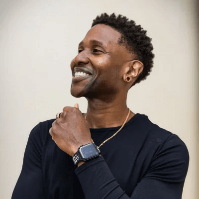 Ervin Lamont Coty smiling in a black shirt